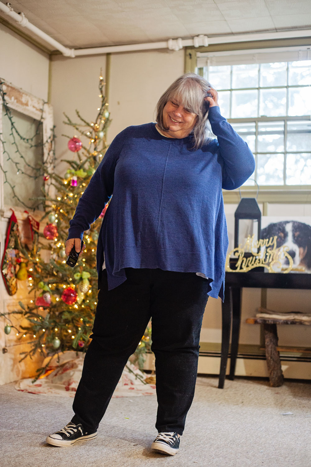 bettye wearing cobalt blue sweater in front of christmas tree