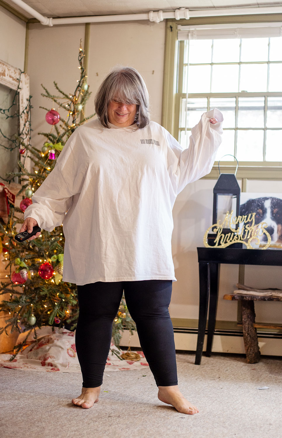 bettye wearing you matter most tee shirt and leggings in living room
