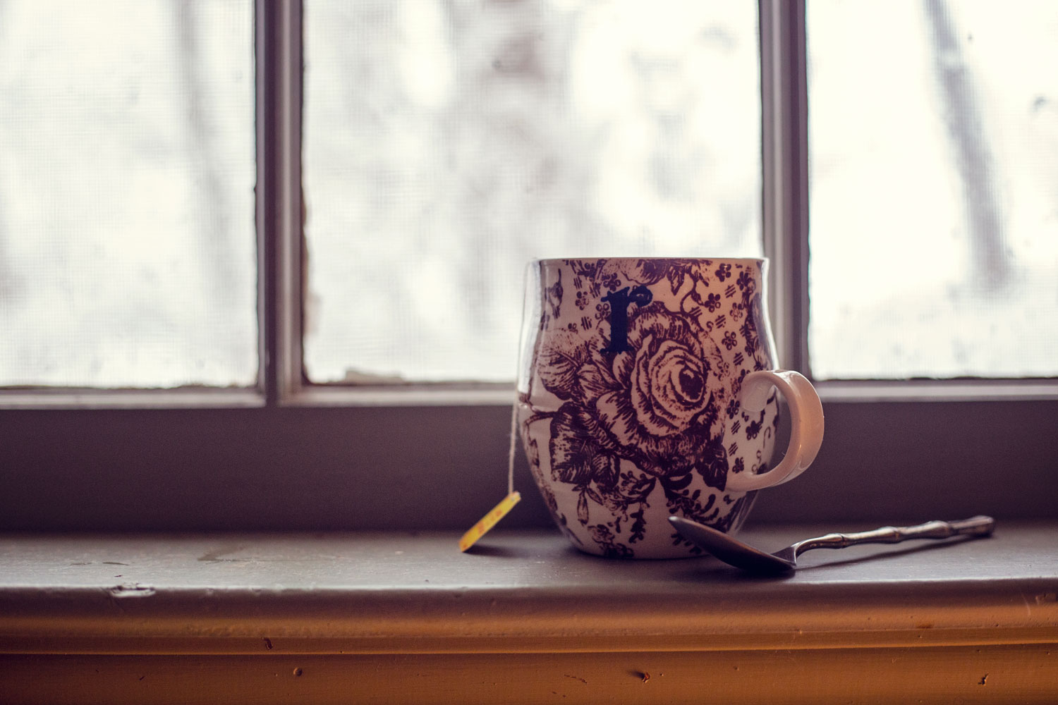 mug of tea on snowy windowsill