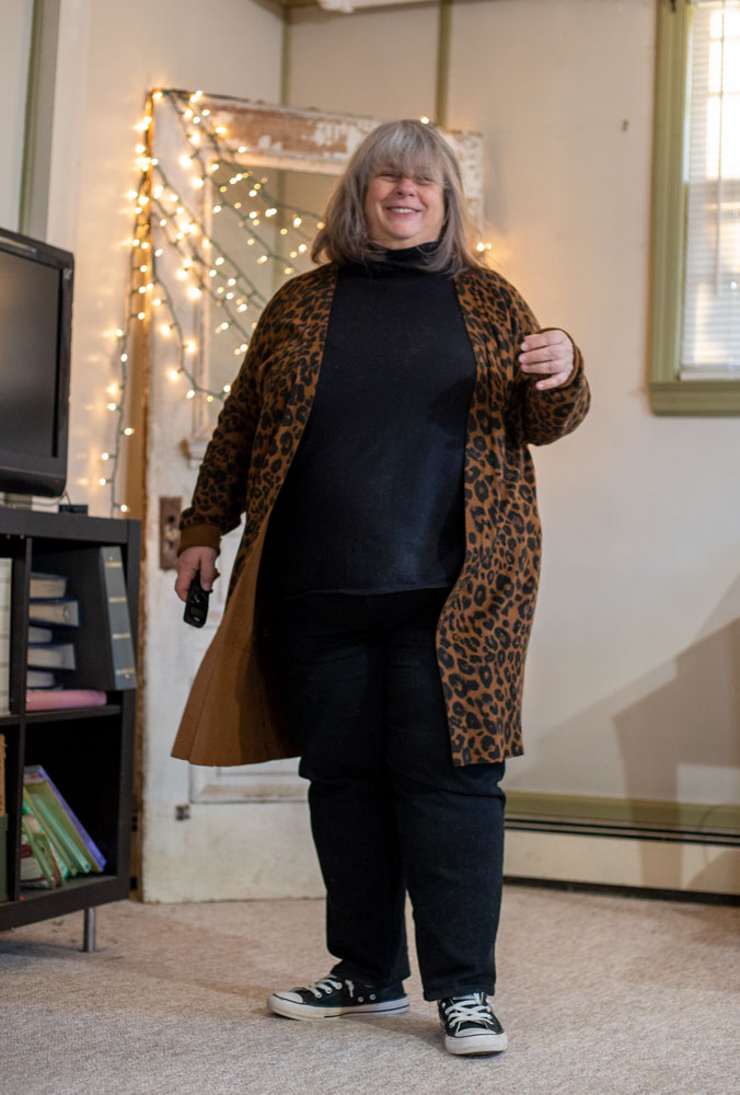 bettye standing in living room in leopard cardigan