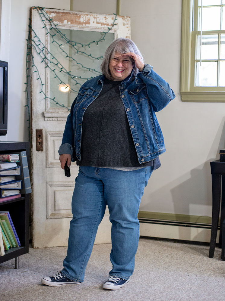 bettye standing in living room in denim jacket